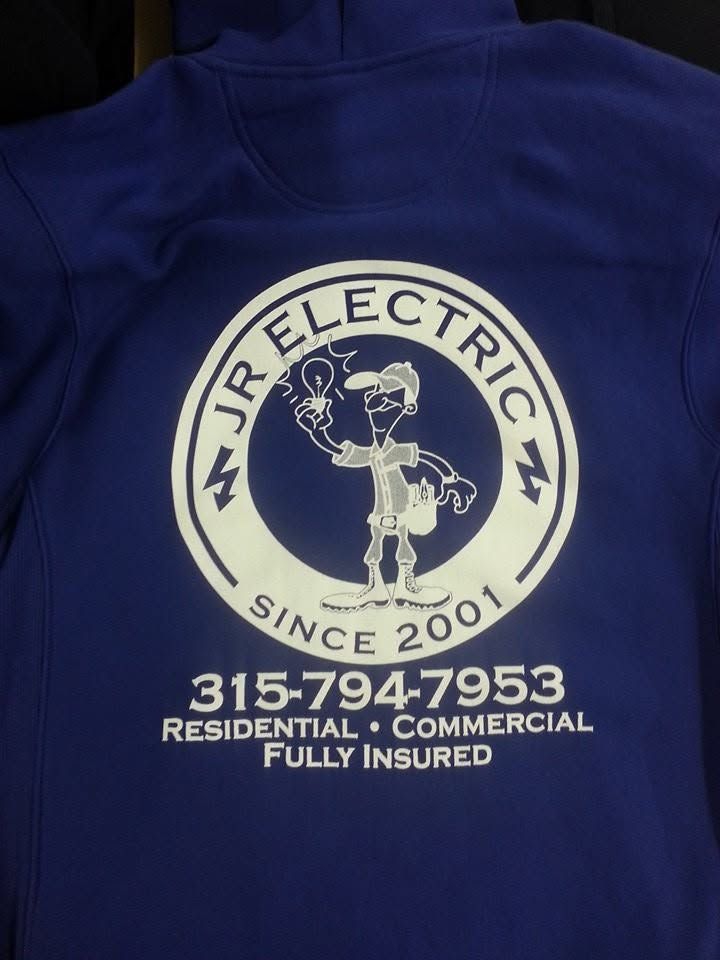 Blue shirt with an “IR Electric” logo, electrician illustration, phone number, and “Residential • Commercial • Fully Insured” text