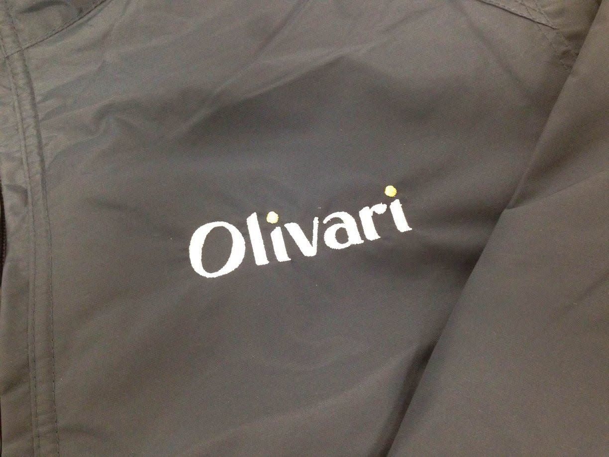 Gray fabric with the white embroidered word “Olivari”