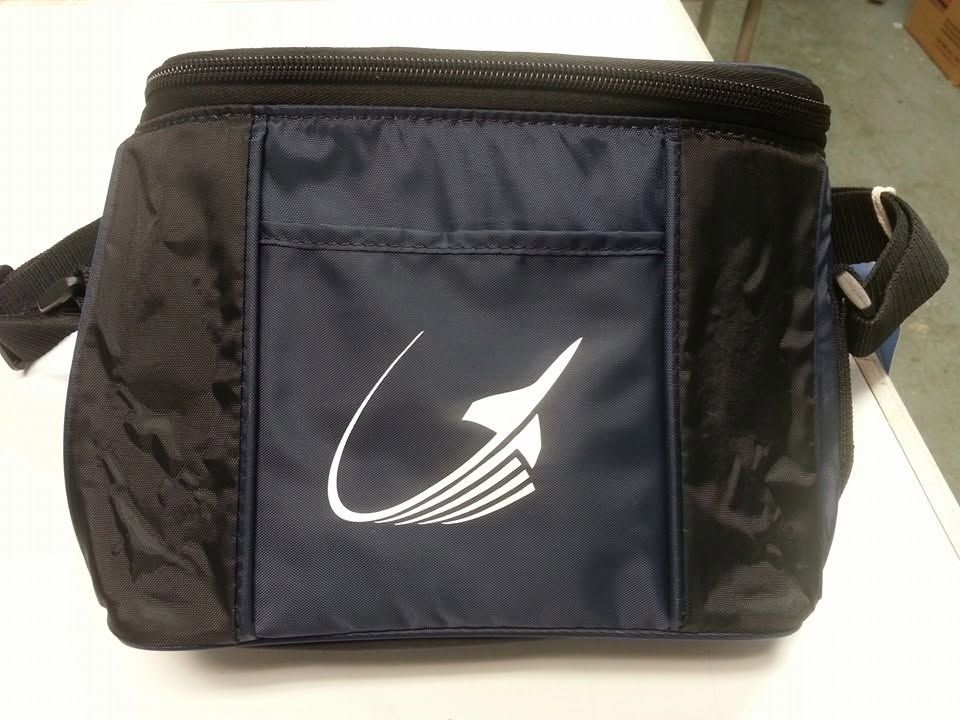 Black insulated lunch bag with white logo and side handles on a light surface