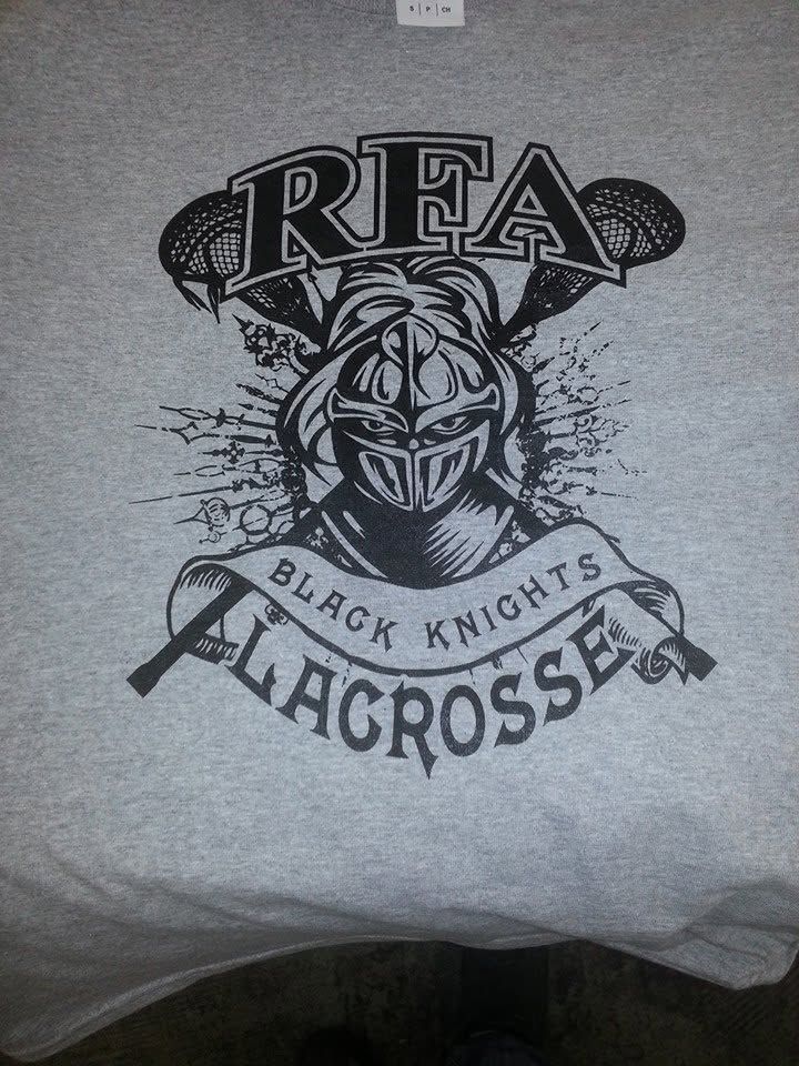 Gray T-shirt with an RFA Black Knights Lacrosse knight helmet logo in black and white