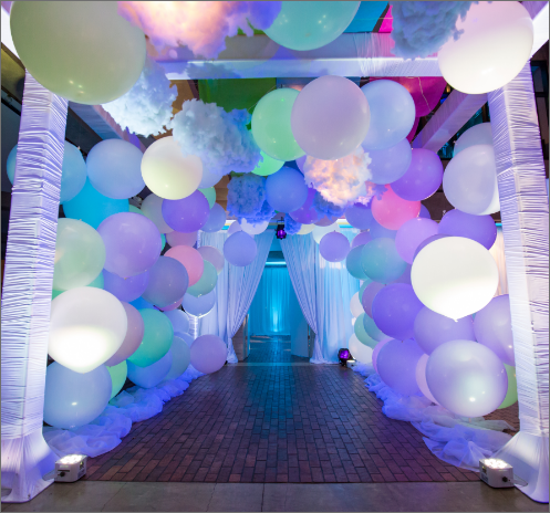 A hallway filled with colorful balloons and lights