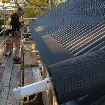 roll out mesh along roof gutter