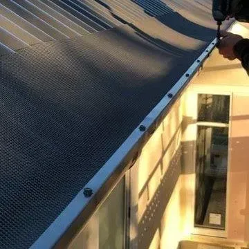 screw in place the angle trim to the edge of your roof gutter