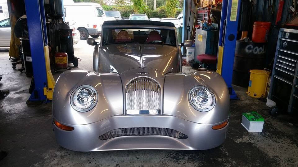 Silver vintage-style car in an auto shop garage, front view on a lift with tools nearby | Tony's European Auto Service