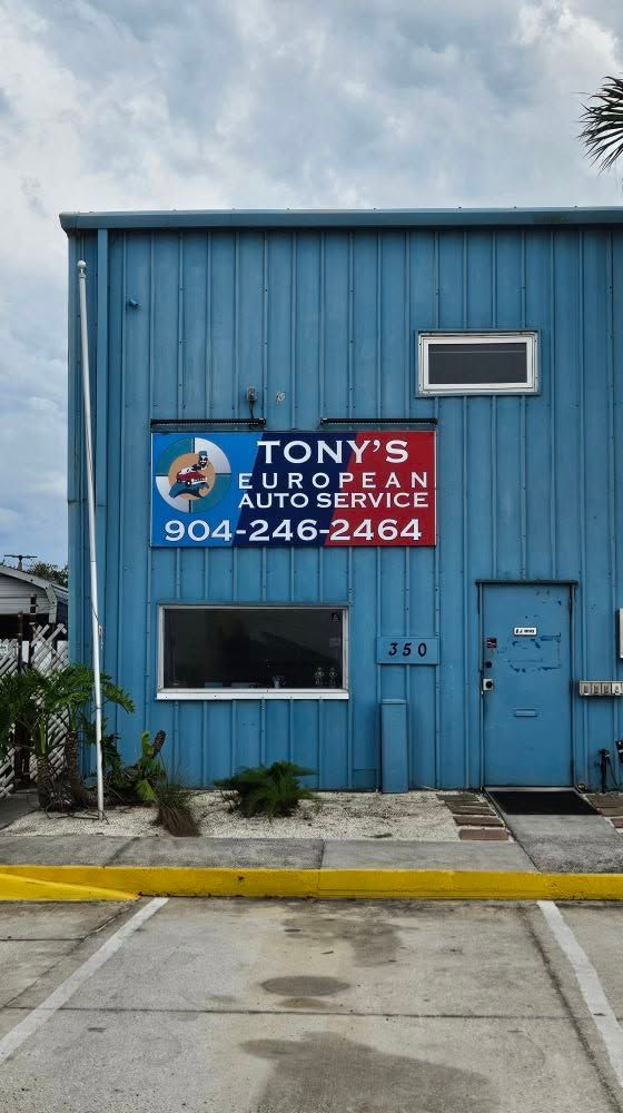Blue building with a Tony’s European Auto Repair sign and sidewalk in front | Tony's European Auto Service