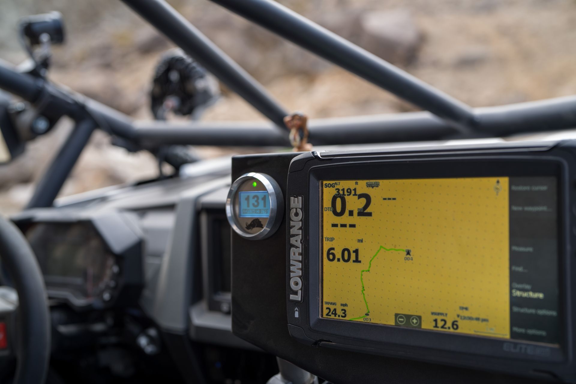 Yellow diagnostic display mounted on a black frame in an off-road vehicle cockpit