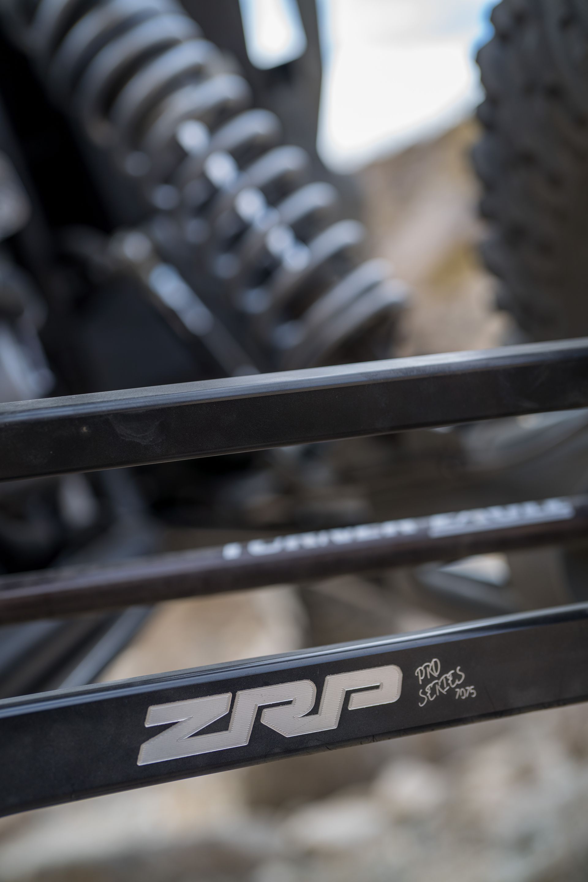 Close-up of a black bike frame with a ZRP logo and rear suspension components