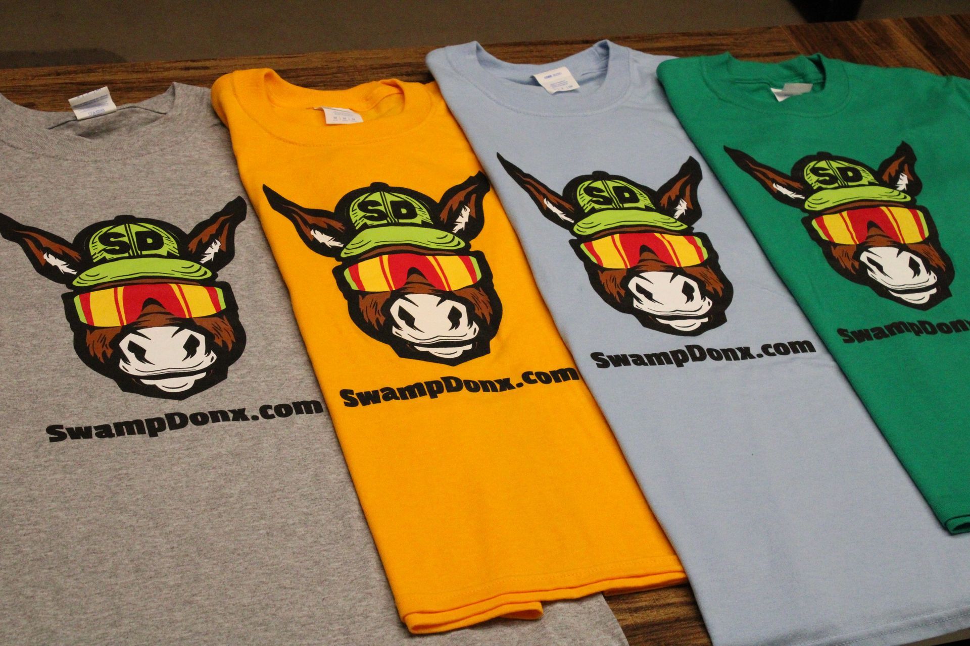 Four shirts with donkeys on them are stacked on top of each other