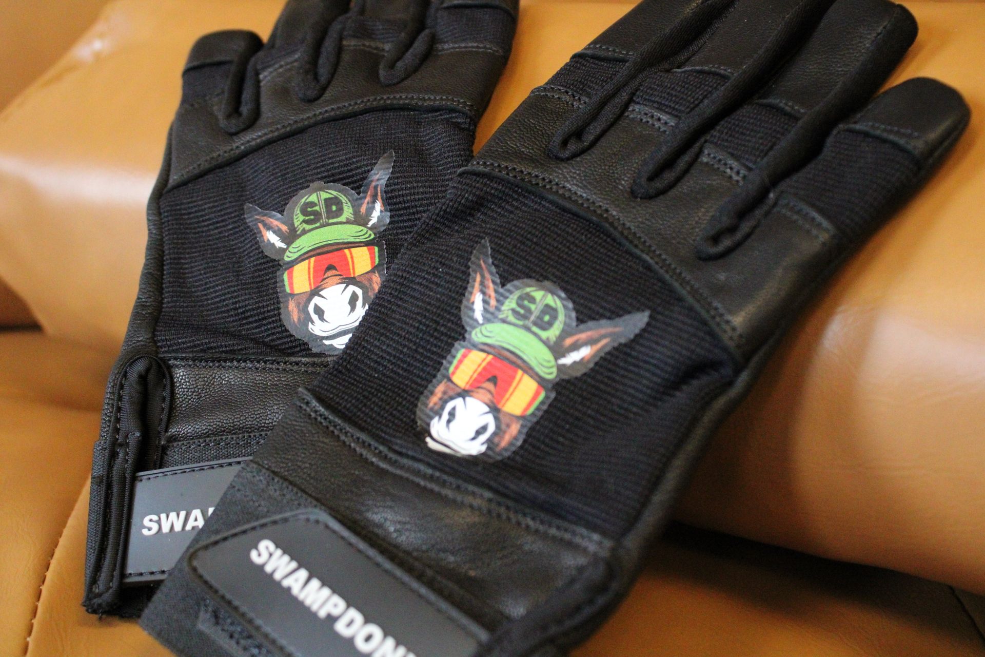 A pair of black gloves with a donkey on them