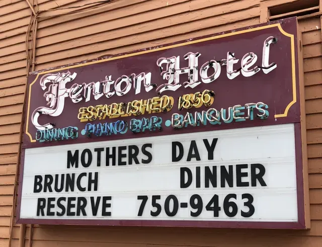 Sign for Fenton Hotel, established 1856, with announcement for Mother's Day brunch and dinner. Phone number provided.