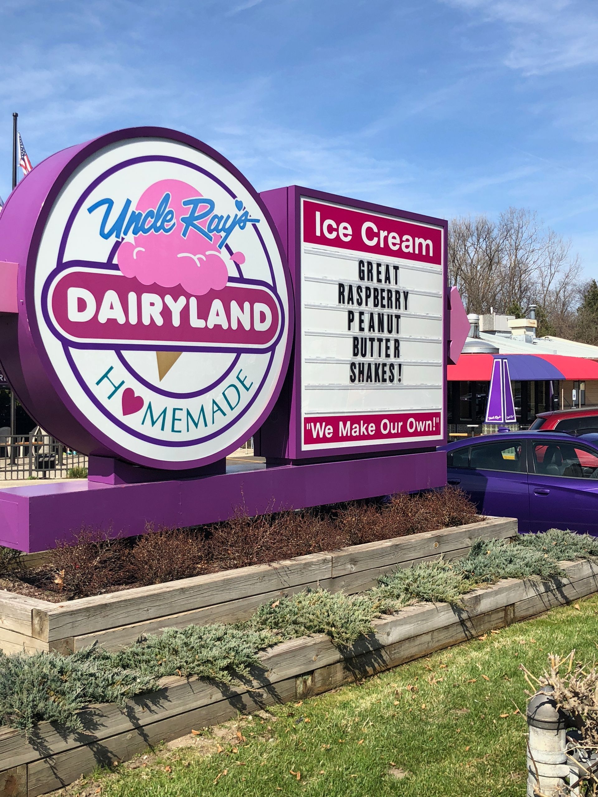 Purple and white sign for Uncle Ray's Dairyland homemade ice cream shop, with a list of shakes.
