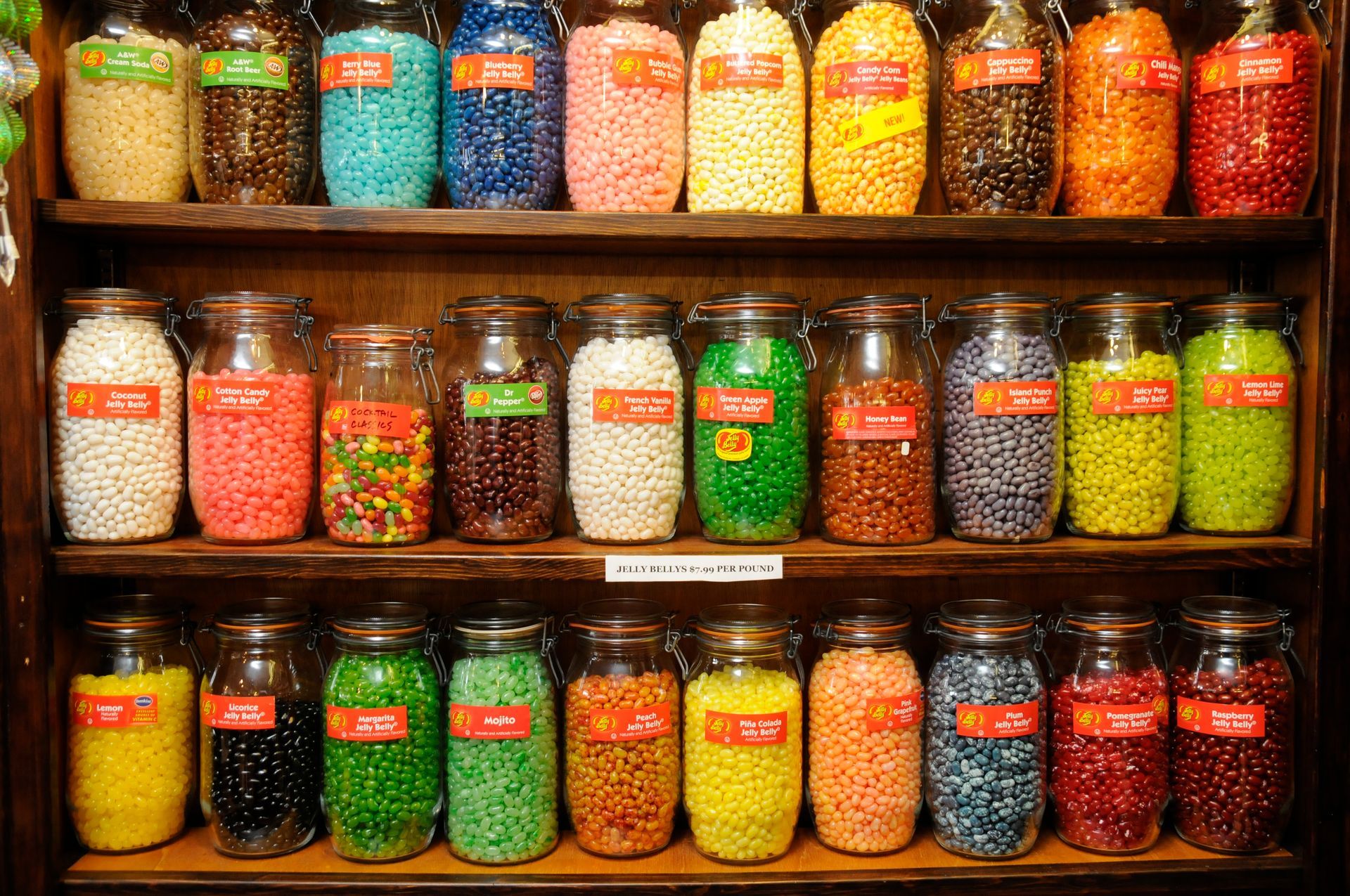 Shelves filled with glass jars of colorful candies in a shop.