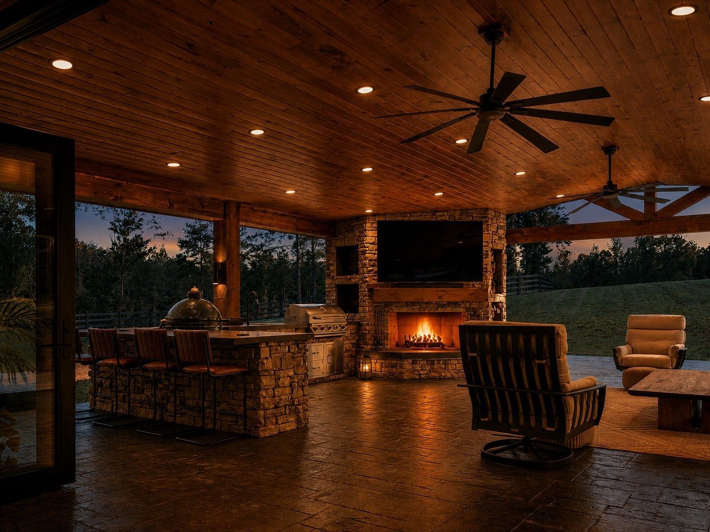 Covered outdoor patio with stone fireplace, wooden ceiling, and seating at dusk