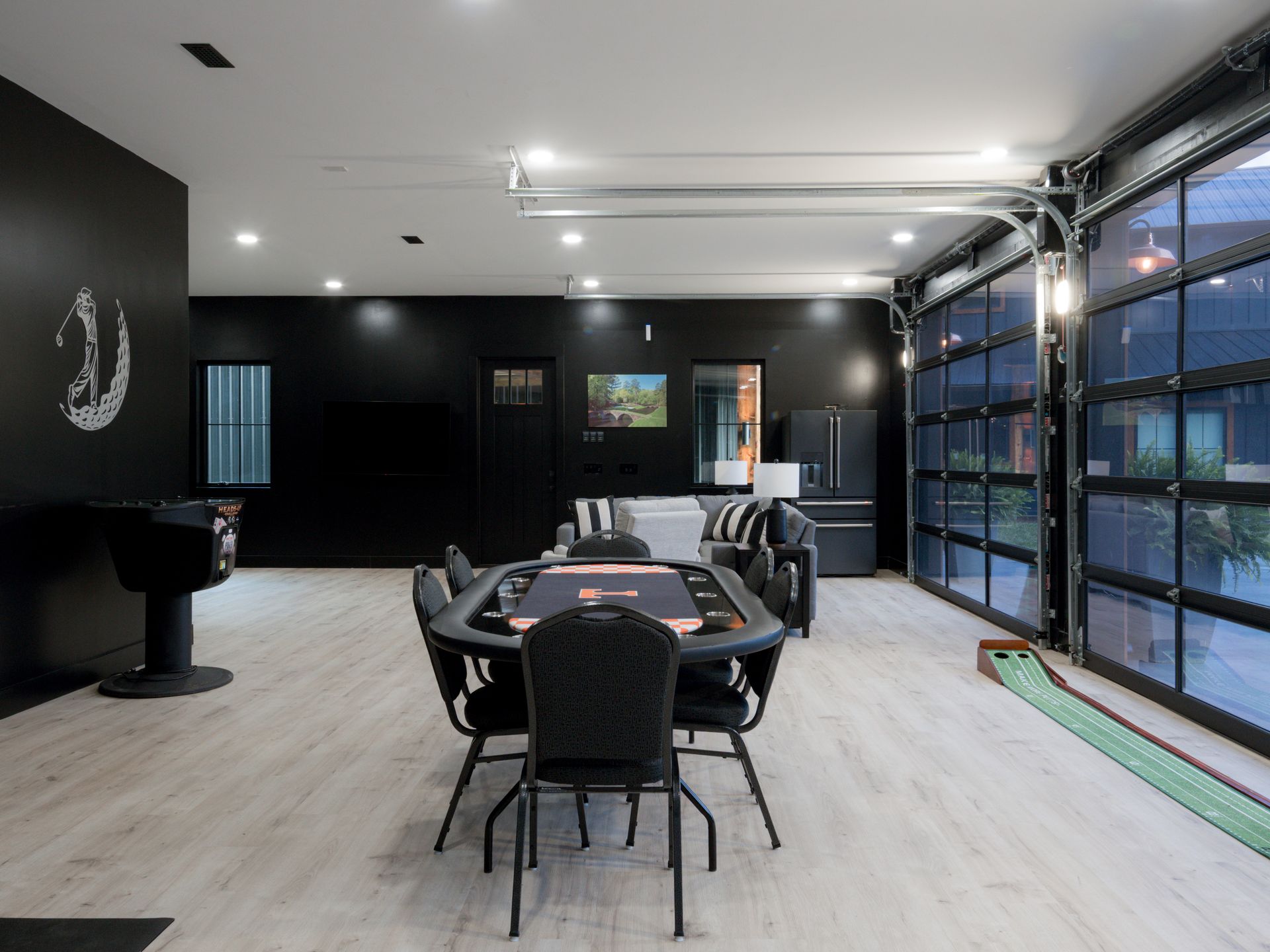 Modern dining room with a long table, black chairs, and floor-to-ceiling windows on the right