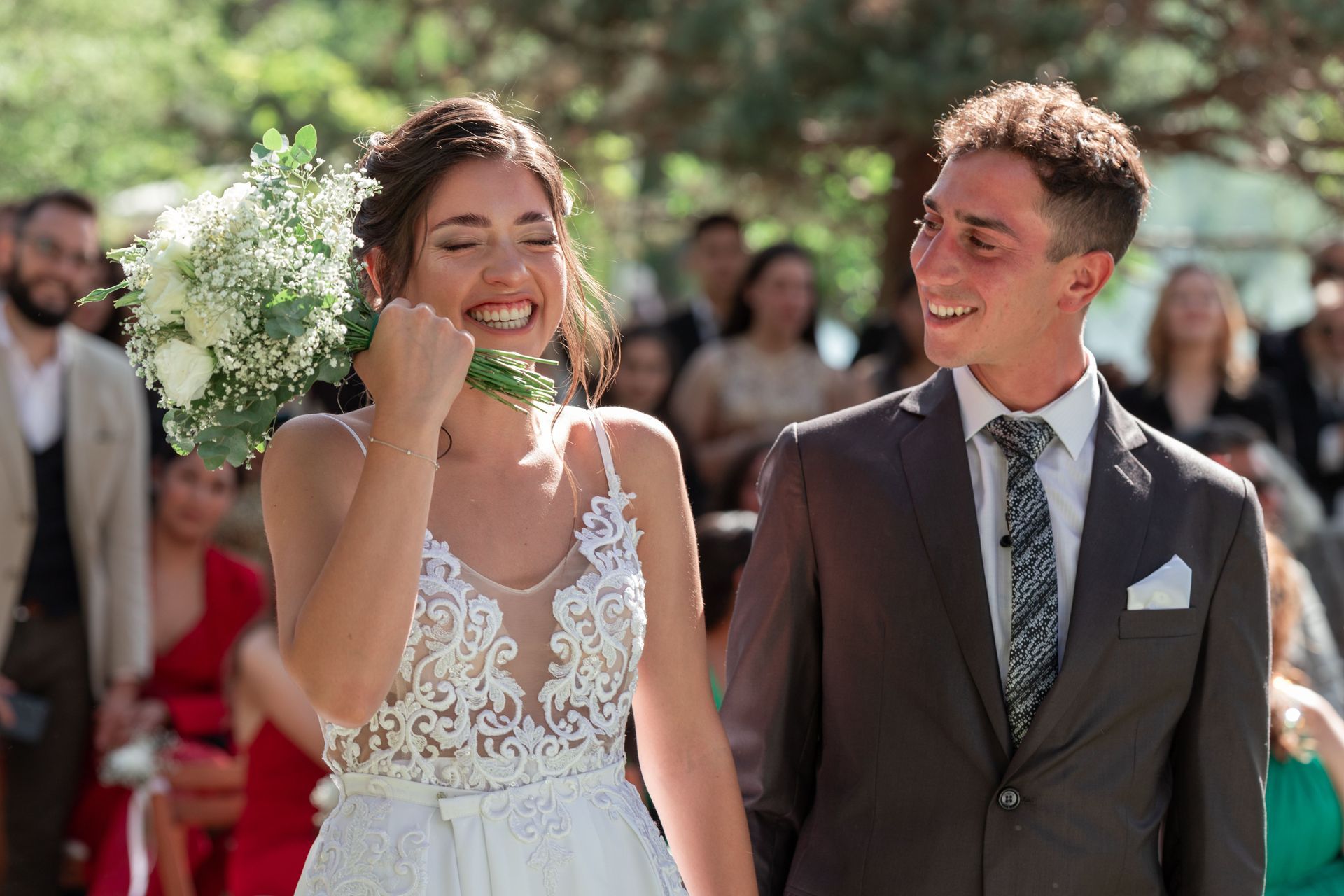 Bride and groom smiling during an outdoor wedding ceremony