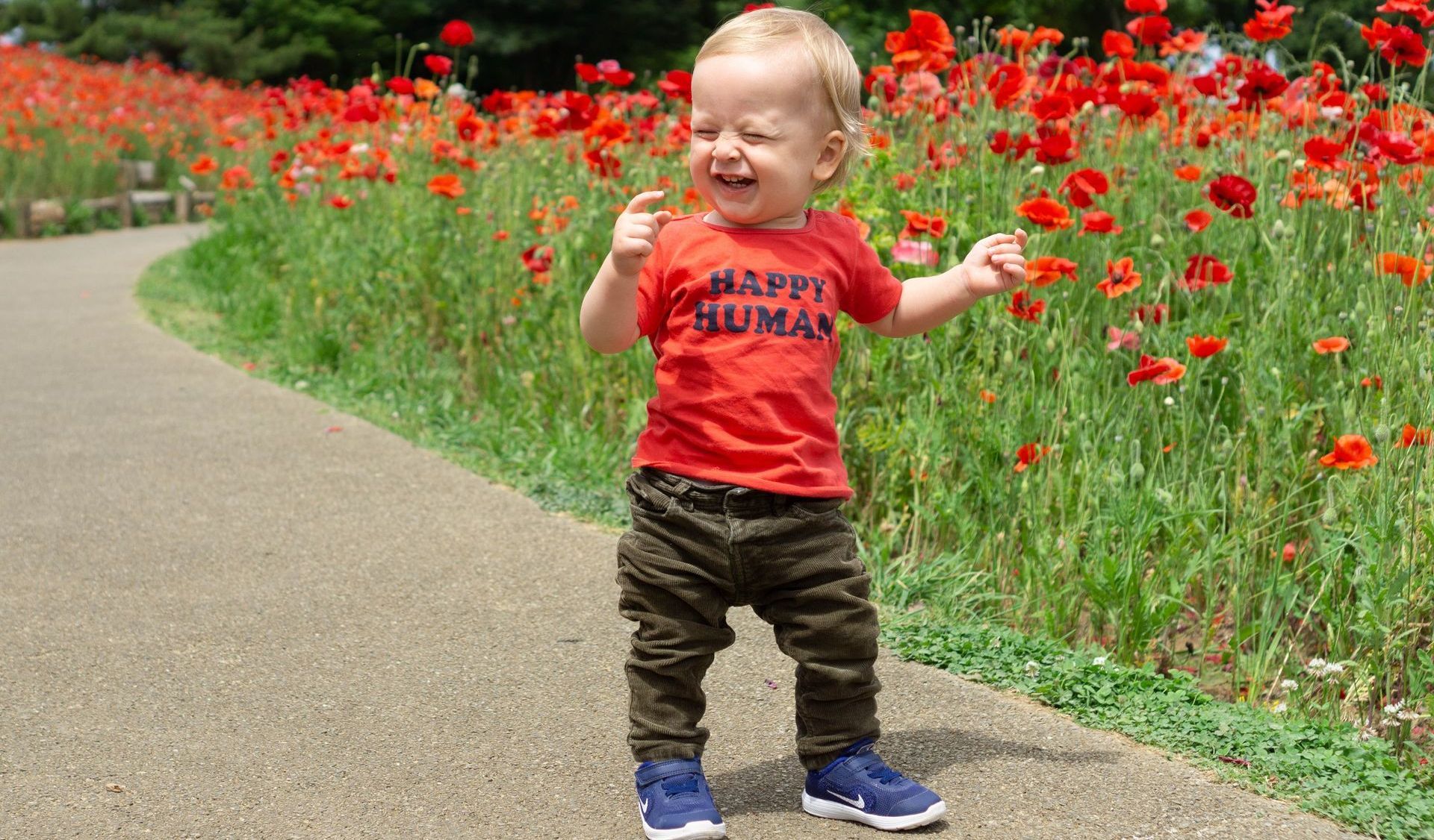 baby closing eyes around flowers