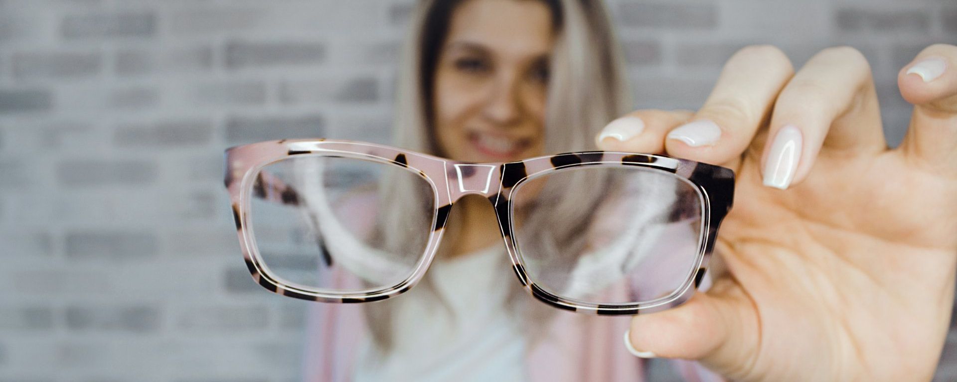 woman holding glasses