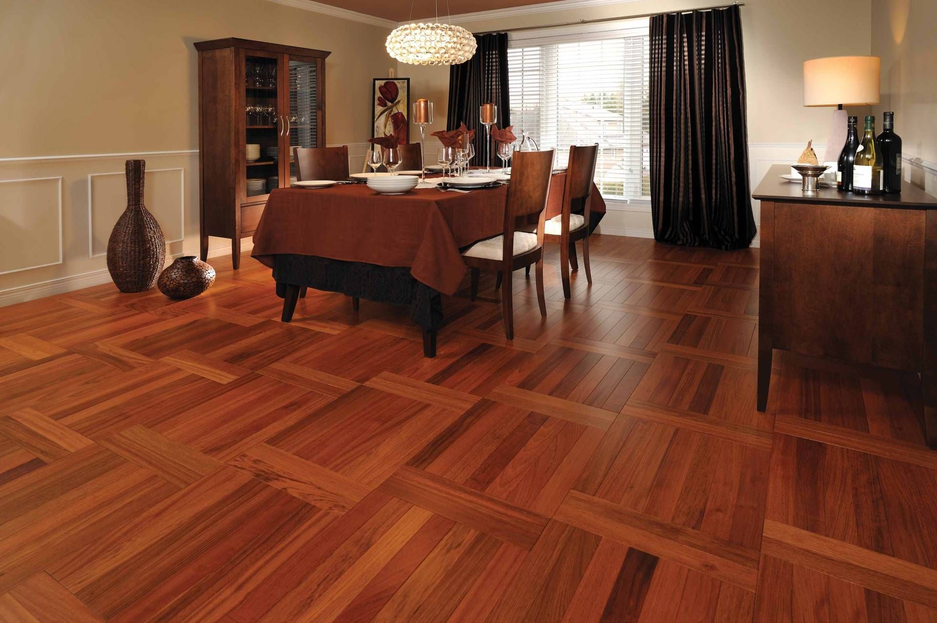 Dining room with polished hardwood floor, table, chairs, cabinet, and warm sunlight through curtains