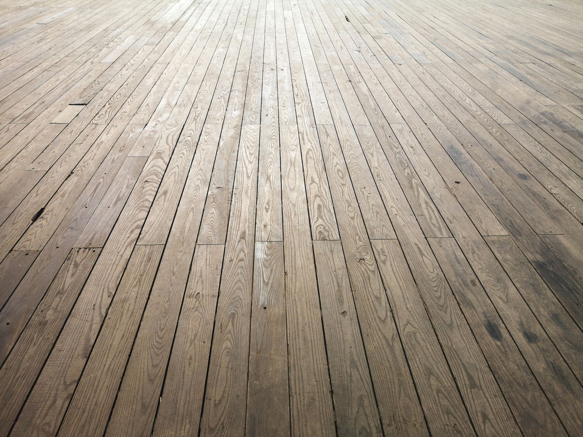 Wooden plank floor with sunlight streaming across it