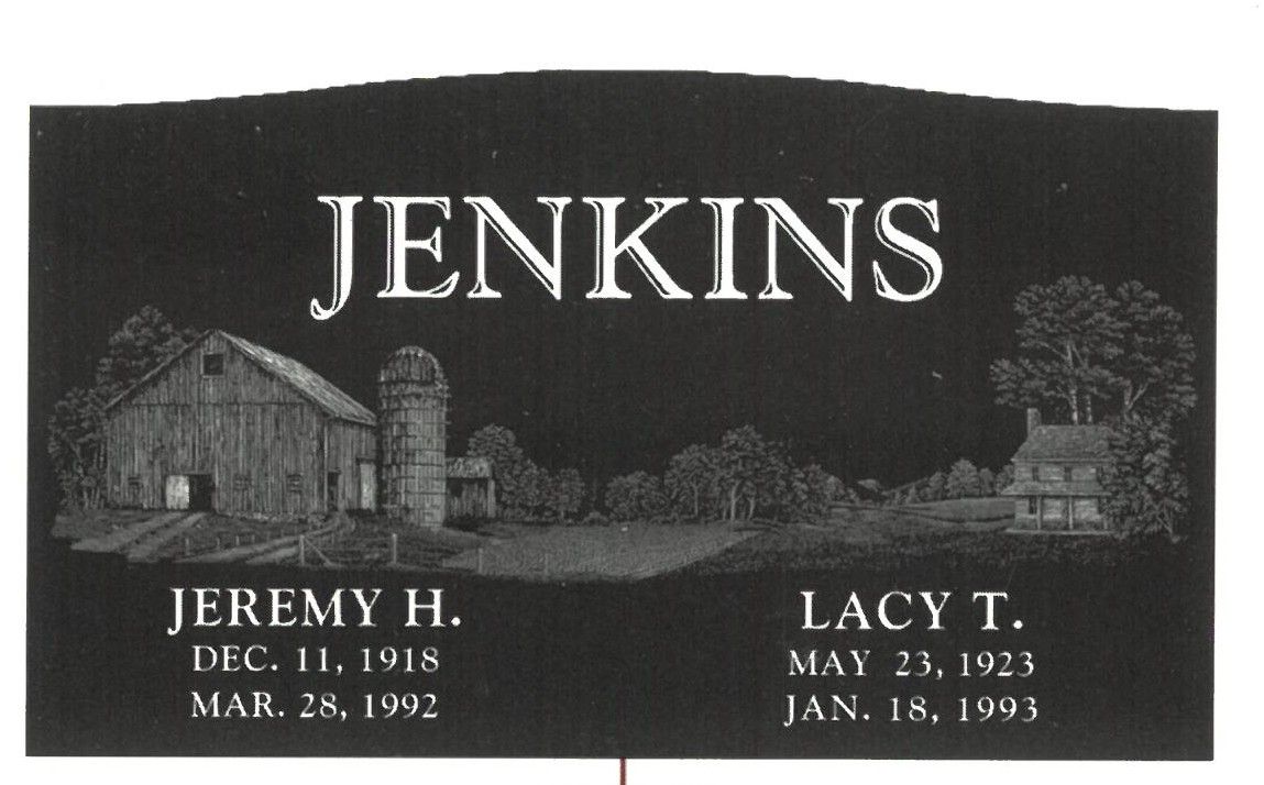 Black-and-white memorial plaque reading “Jenkins” with two names, dates, and a house and tree illustration