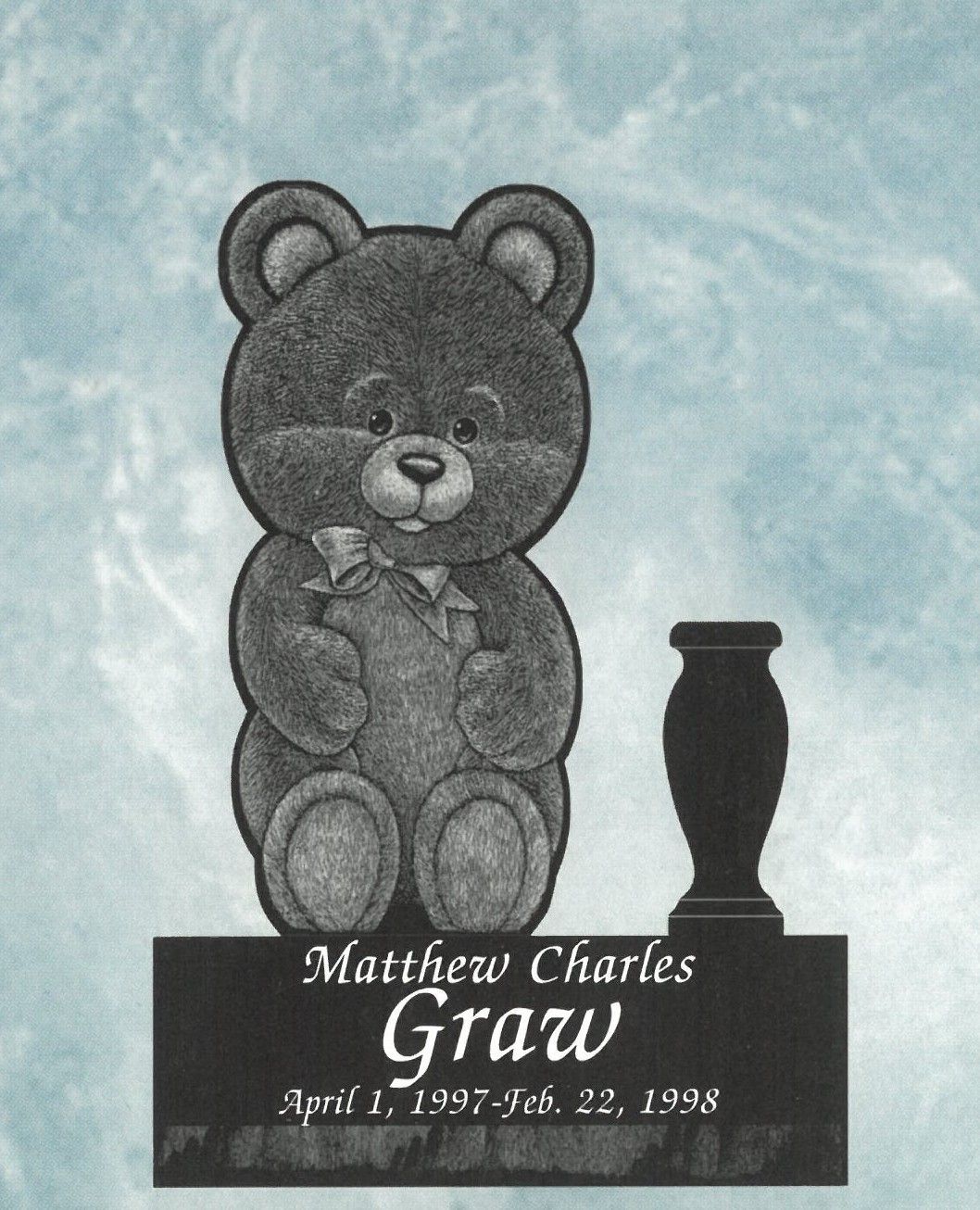 Teddy bear headstone with name Matthew Charles Gray and dates on a black plaque