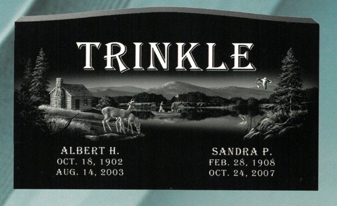 Black granite grave marker engraved “TRINKLE” with two names and dates, set in a cemetery.