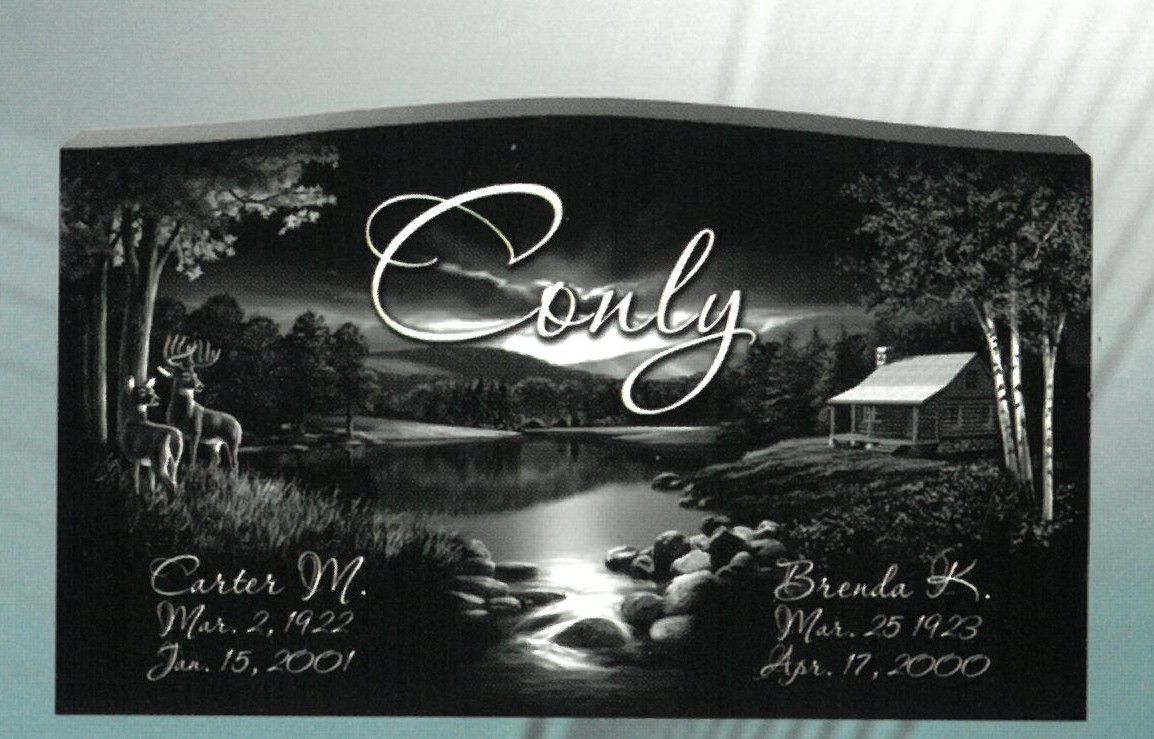 Black memorial plaque with “Conly,” a river scene, trees, and engraved names and dates in white text
