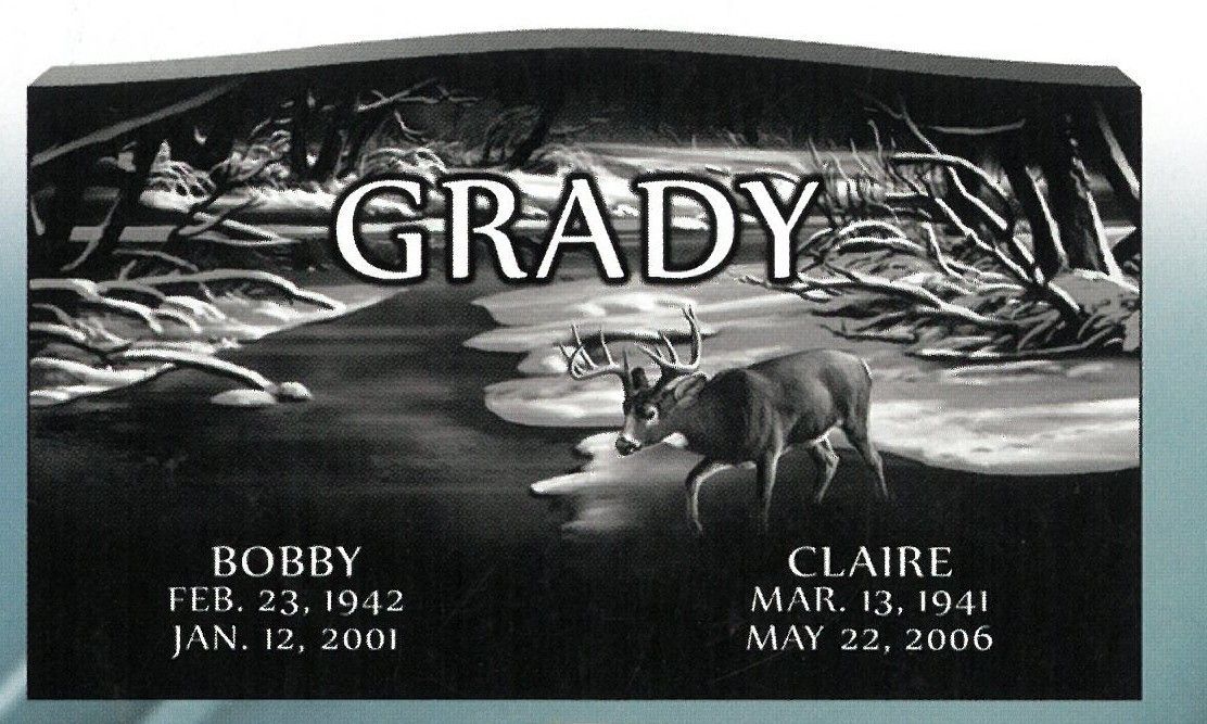 Gravestone engraved “GRADY” with deer scene and names Bobby and Claire at the bottom.