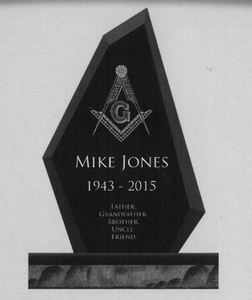 Black Masonic-style memorial plaque for Mike Jones, 1943–2015, on a stone base.