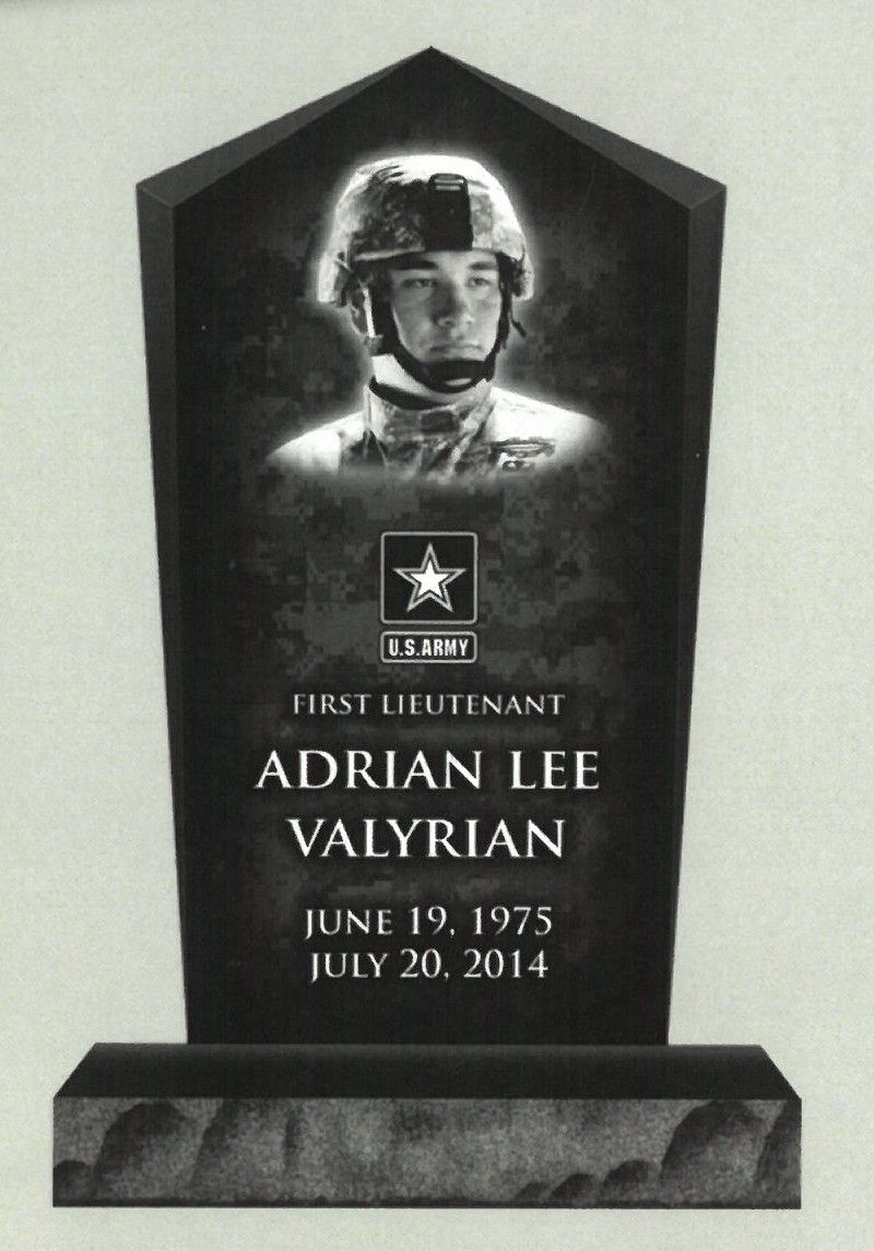 Black memorial plaque with a photo, star emblem, and engraved name and dates for First Lieutenant Adrian Lee Vaylrian.