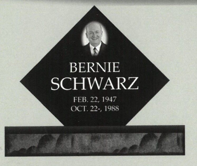 Black memorial plaque for Bernie Schwarz with portrait and dates Feb. 22, 1947–Oct. 22, 1988