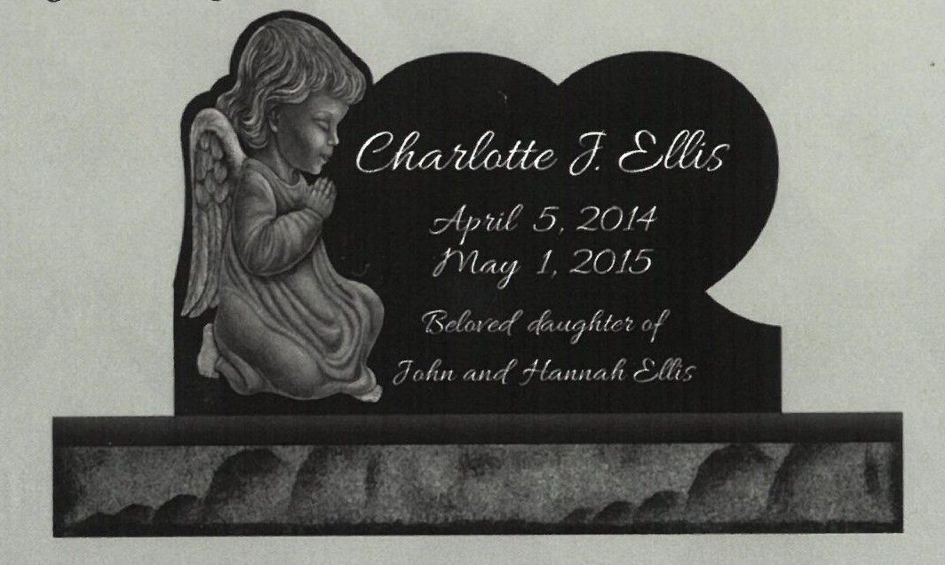 Engraved black memorial plaque with a praying child silhouette and personalized inscription on a stand