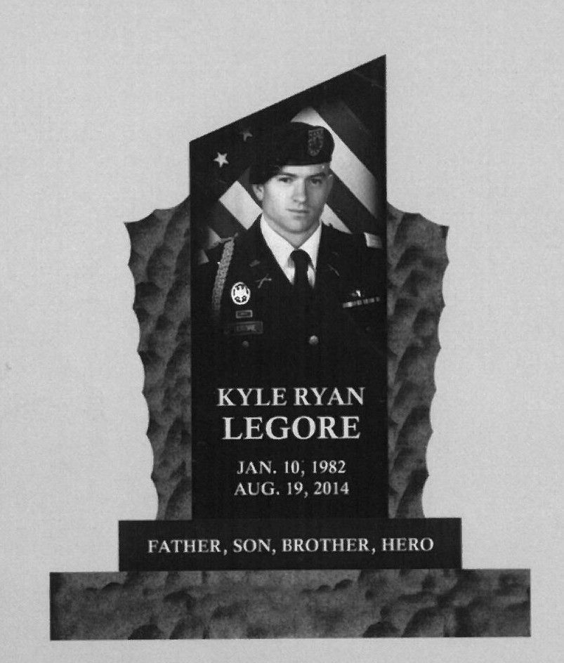 Memorial headstone for Kyle Ryan Legore with portrait in military uniform and the inscription “Father, Son, Brother, Hero.”