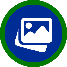 Icon of two white picture frames stacked, a mountain scene and a sun on the top frame, on a blue circle with green border.