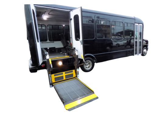 A black and white bus with the door open and a ramp.