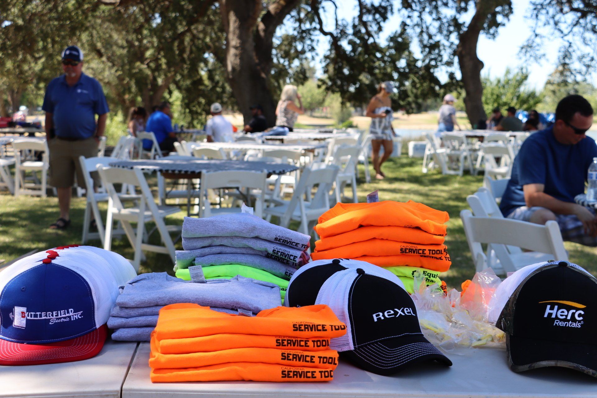 A table with a bunch of hats and shirts on it