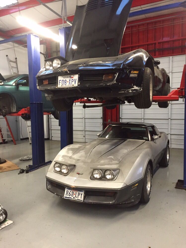 Silver Car Lifted Inside Auto Repair Shop | Discount Inspection and Brakes