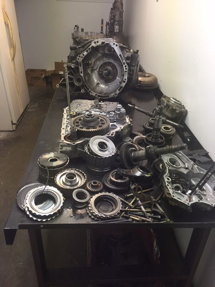 Disassembled Transmission Components On Workbench | Discount Inspection and Brakes