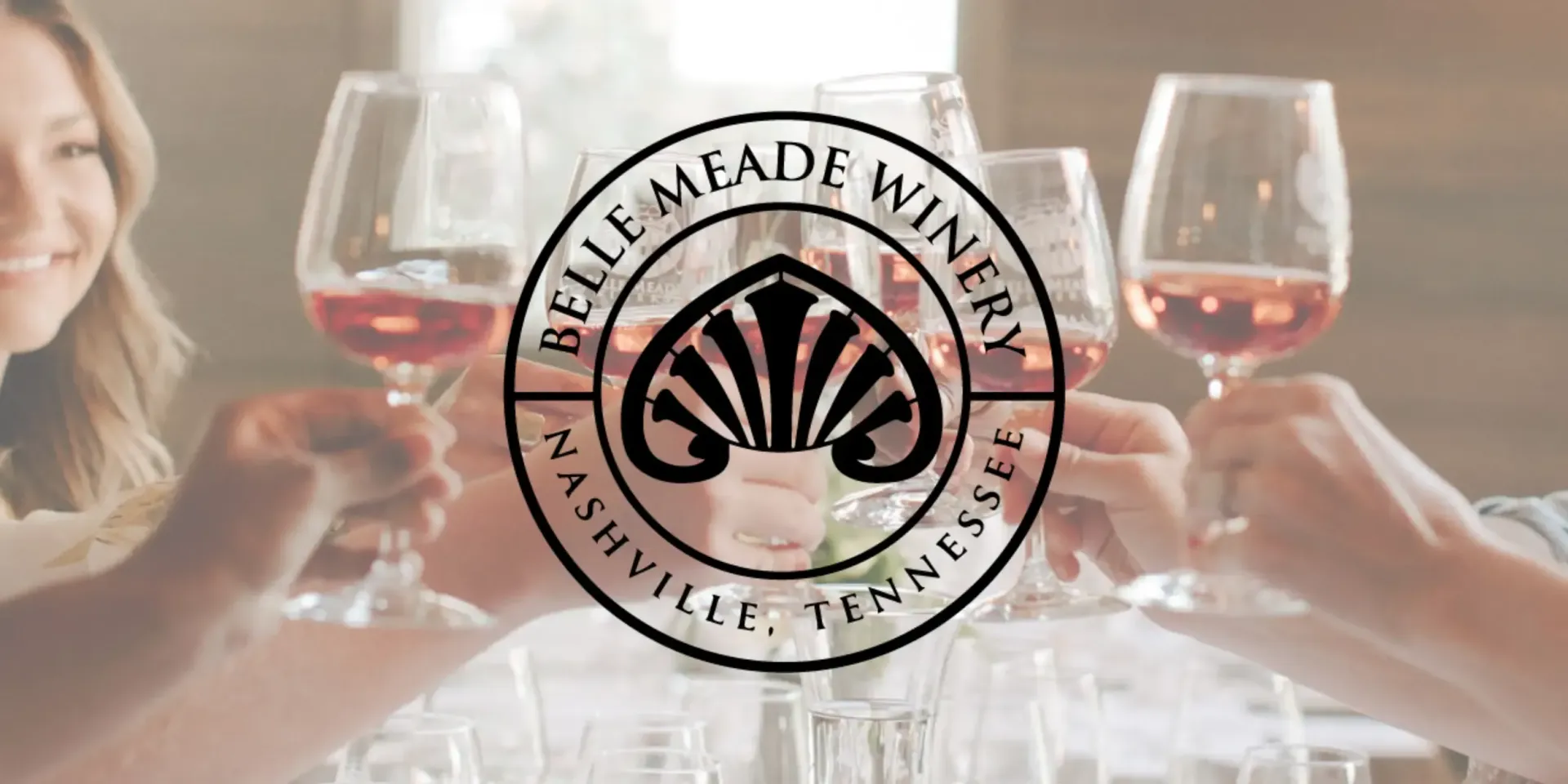 People toasting with wine glasses, Belle Meade Winery logo in the center. Nashville, Tennessee.