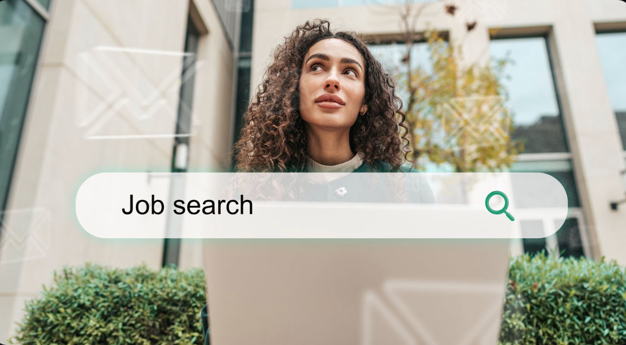 Person looking at a laptop with a “Job search” bar overlay in a modern office setting