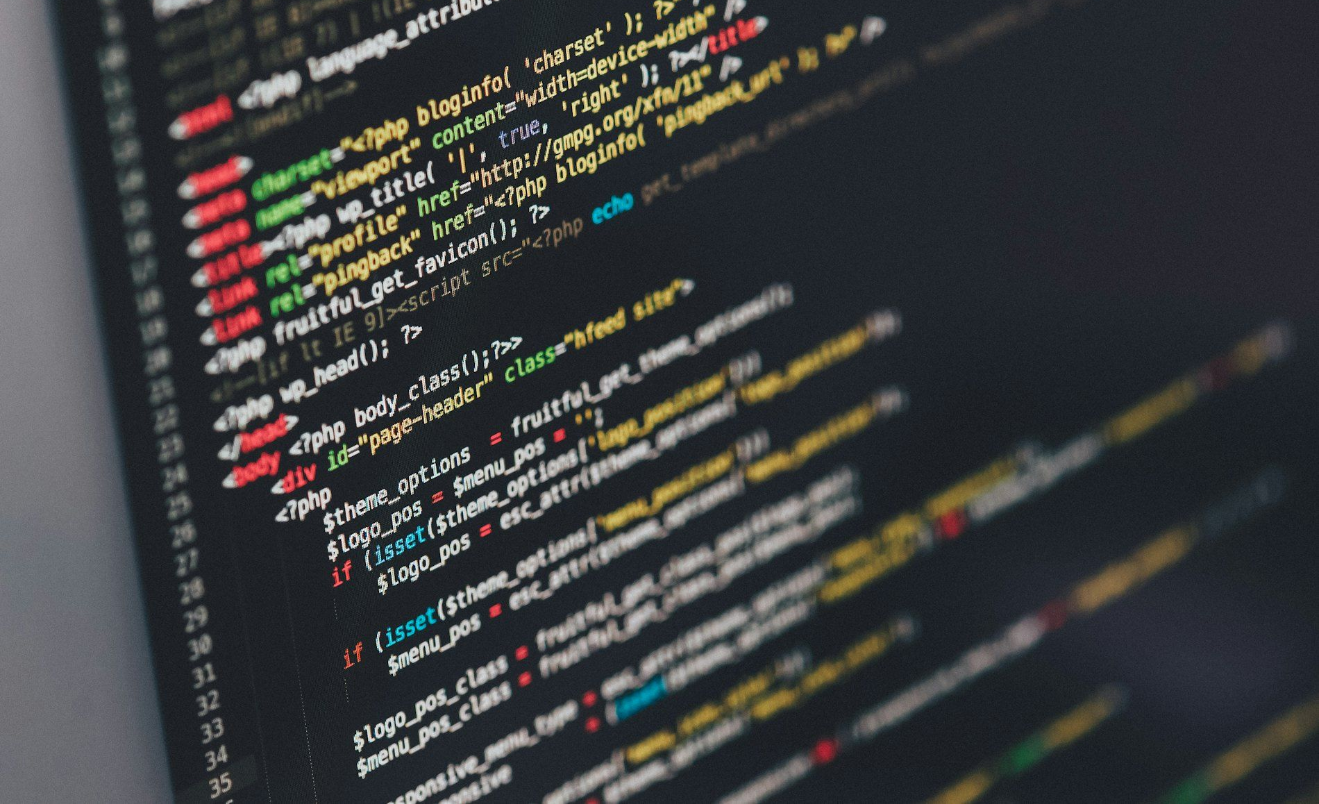Colorful programming code displayed on a dark computer screen, angled close-up