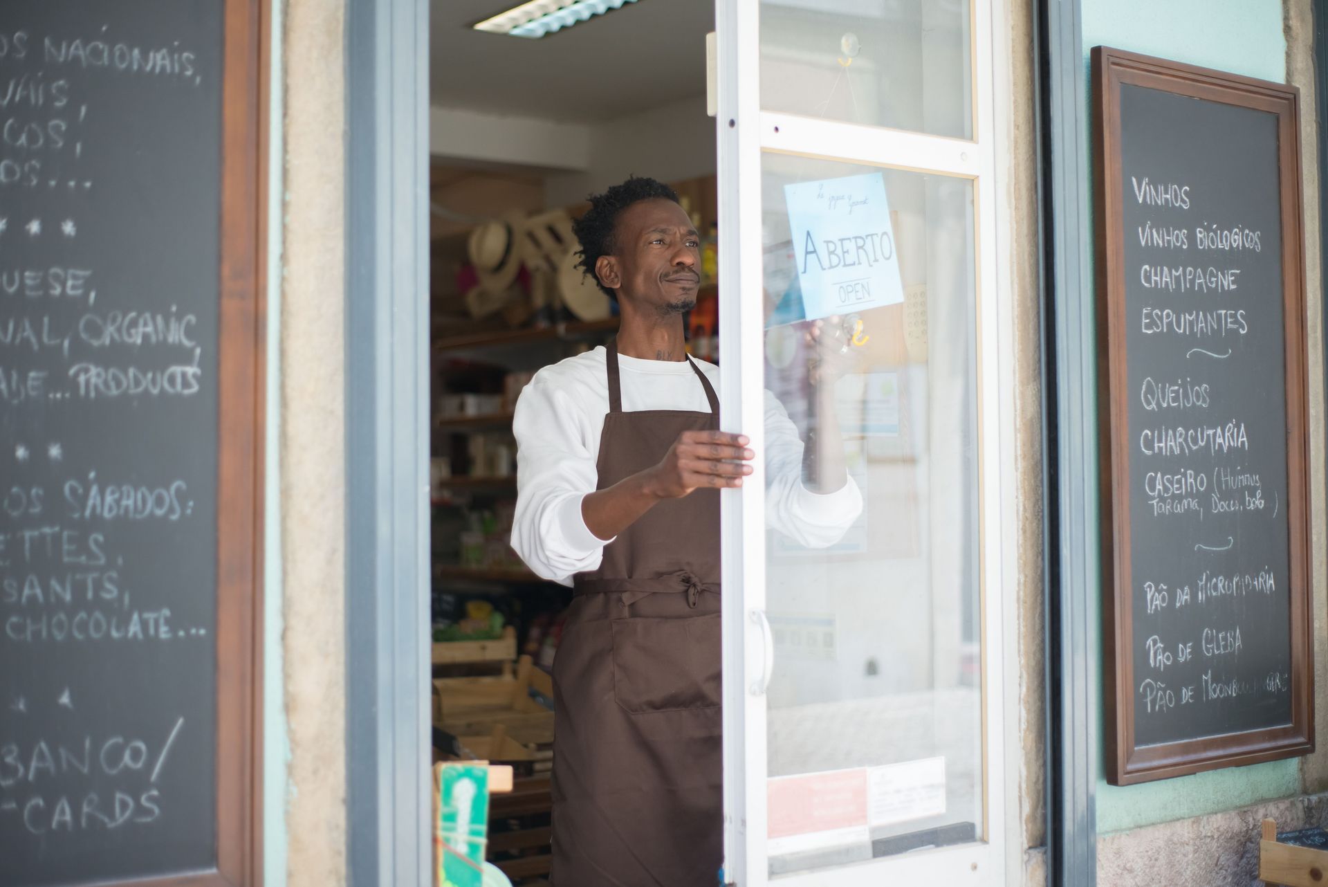 Shop owner standing in the doorway of a local store