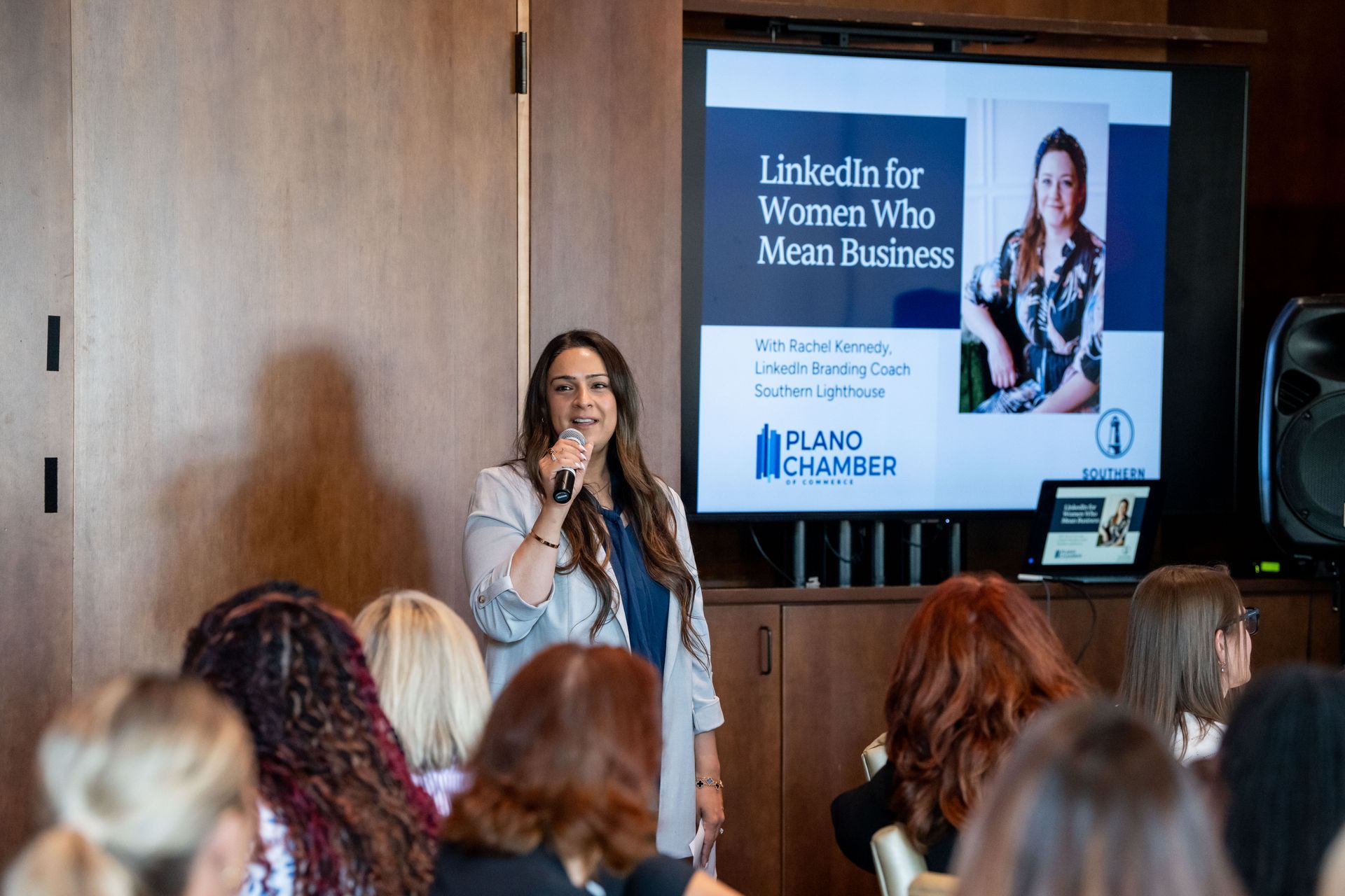 A speaker leads a professional presentation titled