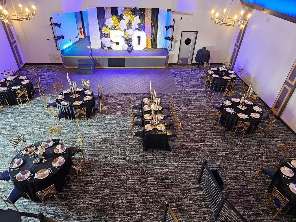 An aerial view of a large room with tables and chairs set up for a party.