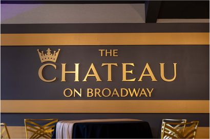 A sign for the chateau on broadway is on a wall