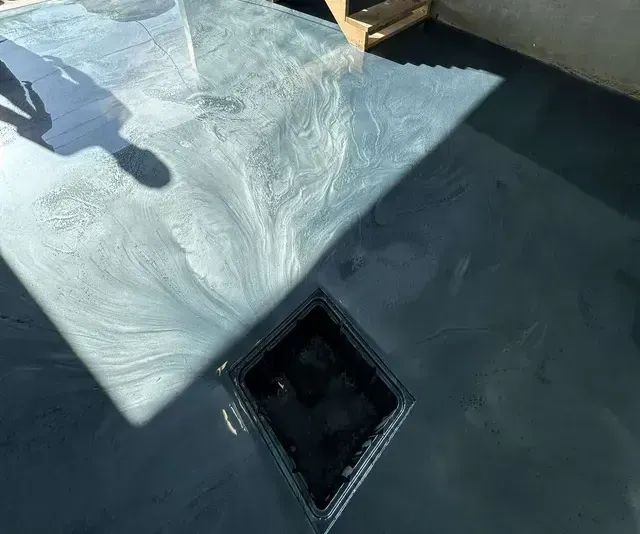 L'ombre d'une personne se reflète sur une table en verre.