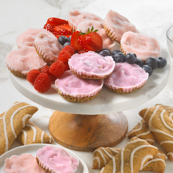soft baked bars topped with frozen yogurt and fresh fruit on a white plate