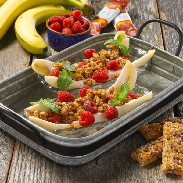 banana split and topped with granola, yogurt and fresh fruit in galvanized serving tray