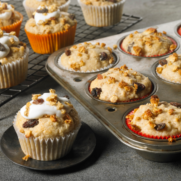 muffins made from banana oat granola bars in muffin tin with additional muffins on cooling rack
