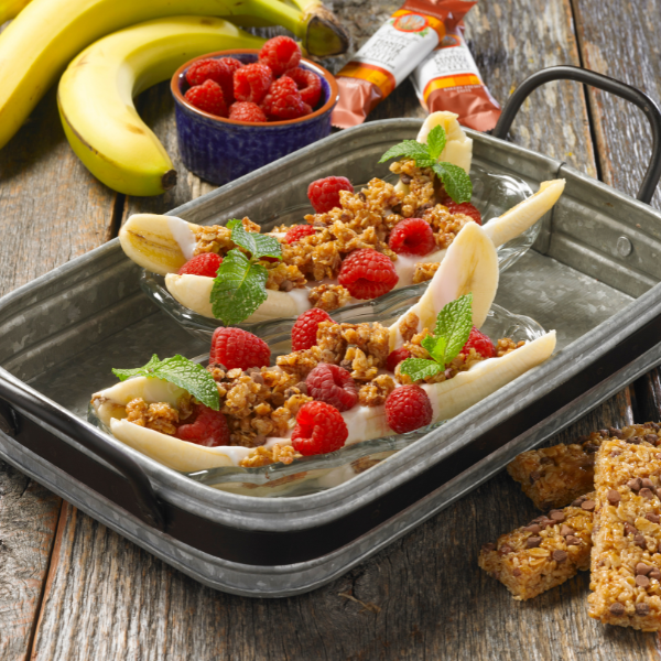 banana split and topped with granola, yogurt and fresh fruit in galvanized serving tray